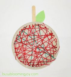 an apple made out of yarn with a toothpick sticking out of the top