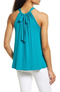 A stretchy knit and a shoulder-showing design put this halter-neck tank at the top of both the comfy and cute wardrobe rankings. 23" length Ties at neck Halter neck Sleeveless, with cutaway shoulders 95% rayon, 5% spandex Machine wash, dry flat Imported Women's Clothing Versatile Sleeveless Halter Top With Tie Back, Summer Halter Neck Knit Top, Casual Stretch Halter Top Sleeveless Blouse, Versatile Sleeveless Top With Tie Back, Versatile Stretch Camisole Top, Casual Stretch Halter Top, Versatile Halter Neck Top For Day Out, Spring Halter Neck Knit Top, Chic Racerback Tops For Spring