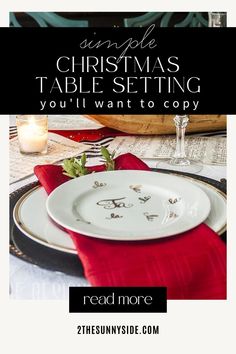 a christmas table setting with red napkins and place settings on the plate, along with candles