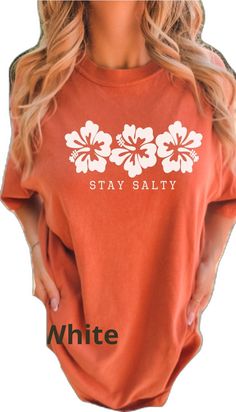 White Tropical Surfing Top, Spring Vacation T-shirt With Hibiscus Print, Orange Relaxed Fit T-shirt For Beach, White Hawaiian Surfing Top, Orange Tropical Top For Beach Season, Orange Tropical Tops For Beach Season, Tropical Orange Tops For Beach Season, Orange Relaxed Fit Top For Beach Season, Relaxed Fit Orange Top For Beach Season