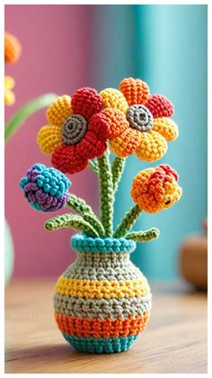 a crocheted vase with colorful flowers in it