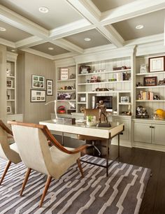 a home office with built - in shelving and desk