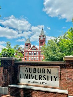 the entrance to auburn university with a clock tower in the background