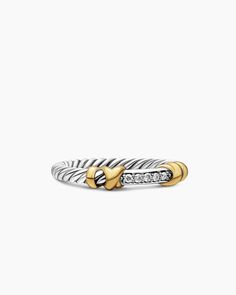 two tone gold and silver ring with diamonds on the outside, set against a white background