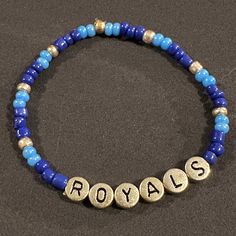 Whether celebrating the 1985 or 2015 World Series, or cheering on today's Boys in Blue, this bracelet looks great in any era. Blue Adjustable Bracelets For Team Spirit, Blue Team Spirit Beaded Bracelets As Gift, Personalized Blue Bracelets For Game Day, Personalized Blue Bracelets For Sports Events, Adjustable Team Spirit Bracelets With Letter Beads, Blue Beaded Bracelets For Team Spirit Gift, Adjustable Blue Jubilee Charm Bracelet, Team Spirit Letter Beads Bracelets As Gift, Team Spirit Letter Beads Bracelets For Gift