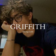 a young man wearing glasses sitting in front of a laptop computer with the words griffith on it