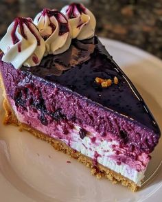 a piece of cheesecake on a plate with chocolate and raspberry toppings