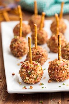 small appetizers with toothpicks on a white plate, ready to be eaten