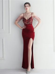 This burgundy mermaid dress is a sweet escape from the regular, designed for exquisite evenings like prom or formal events. The velvet gown flows smoothly to the floor, caressed by delicate spaghetti straps that introduce the tassel beading cap sleeves. A high slit provides a modern and tasteful reveal, complemented by a zipper-up back for a perfect fit. Remarkably priced under $150, this gown offers an opulent look without a lavish price tag. Dress Fishtail, Dress Pesta, Social Dresses, Long Evening Dress, Designer Evening Dresses, Fishtail Dress, Annual Meeting, Custom Wedding Dress, Split Dress