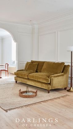 a living room scene with focus on the couch and coffee table in the centerpiece