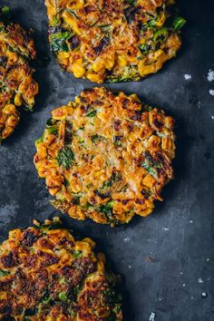 three fritter cakes with cheese and broccoli on a black surface, top view