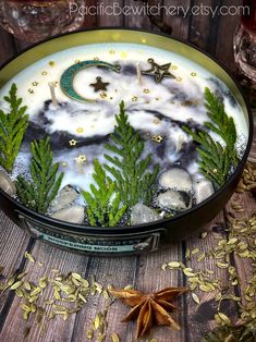 a bowl filled with plants and rocks on top of a wooden table