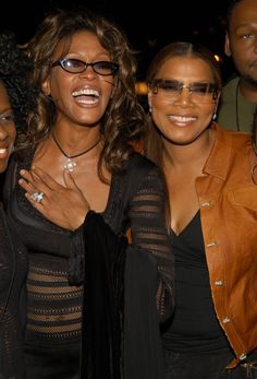 three women standing next to each other smiling