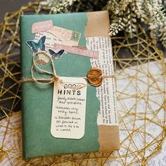 a gift wrapped in brown paper and tied with twine on top of a table