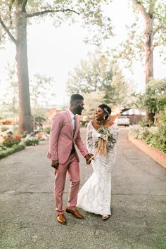 a bride and groom walking down the street