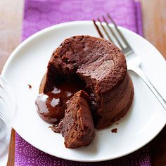 a chocolate cake on a white plate with a fork