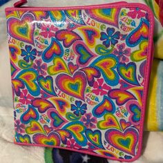 a colorful purse sitting on top of a white blanket