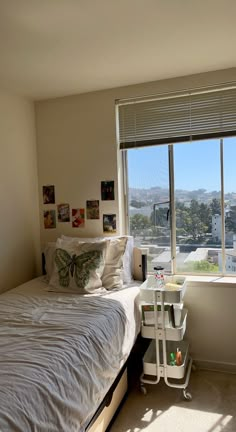 a bed sitting next to a window in a bedroom