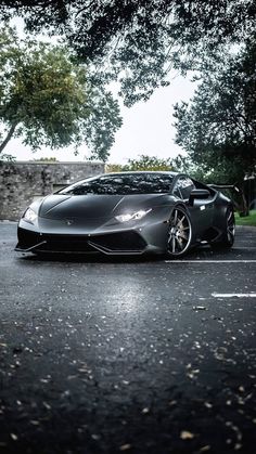 a black sports car is parked on the street