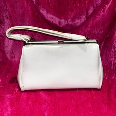 D E S C R I P T I O N This Is A 1950's White Cream Colored Patent Leather A Frame Bag With Silver Tone Hardware. M E A S U R E M E N T S Bag Width: 5” Bag Height: 7.5” Bag Length: 13” Authenticity Guarantee All Bags Sold In Our Shop Are 100% Guaranteed Authentic Or Your Money Back. Retro Pouch Shoulder Bag With Detachable Handle, Vintage Evening Bag With Detachable Strap And Top Handle, Vintage Pouch Satchel For Evening, Retro Clutch Bag For Everyday Use, Retro Evening Shoulder Bag, Retro Satchel With Removable Pouch, Retro Rectangular Shoulder Bag For Vintage Events, Rectangular Retro Shoulder Bag For Vintage Events, Retro Satchel With Detachable Strap