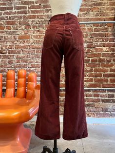 70s Levi's Cabernet Corduroy Flared Jeans Gorgeous seventies Levi's corduroy flared jeans. Talon 42 zipper fly with Levi's signature button closure at the waist. Front and back pockets. Belt loops for your favorite 70s belt. The color is so good! Levi's white tab on the back pocket. These are extremely old Levi's. The Levi's button and the zipper are oxidized. Demarcation and discoloration through out, especially where the hem has been taken down. A fray and a mend near the right hem. A fray on the right front pocket and slightly frayed at the waist. I've added as many photos as I can of this. I love these 70s Levi's and I think the imperfections make them look that much cooler. Please DO NOT purchase if the imperfections bother you.  Measurements: 28" waist 37" hip-hip measurement is key, 70s Style Jeans, 70s Street Fashion, Authentic 70s Fashion, 60s Jeans, 70s Winter Fashion, 70s Trousers, 70s Flare Jeans, 70s Cottagecore, 70s Inspired Outfits