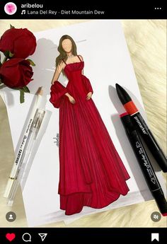 a drawing of a woman in a red dress next to some markers and a rose