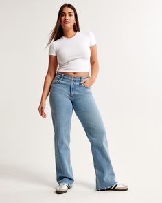 Our Curve Love low rise baggy jeans in a medium wash with a raw hem. This fit features a 8.5” low rise, is slightly relaxed at waist and hips, and eases at the thigh into a baggy, full-length leg shape. We recommend buying your true size for a baggier fit. Size down for a closer fit. Our Curve Love styles add an additional 2” at the hip and thigh to allow room for your curves and eliminate waist gap. This jean is made from our vintage stretch fabric which features both an authentic vintage look Jean Collection, Jean Fits, Female Features, Low Rise Baggy Jeans, Abercrombie Girls, Baggy Jean, Women's Bottoms, Comfortable Jeans, 2024 Christmas