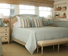 a bedroom with blue and white decor in it