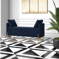 a black and white checkered floor with a blue couch in the center, potted plant next to it