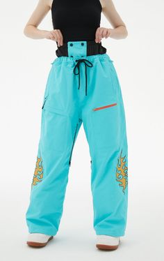 Seal out snow and wet weather with the RandomPow Ladies Snow Trousers. These blue ski pants fit close to the skin and have a soft fleece lining for extra comfort on the slopes. Pants Features: Waterproofing: 20K Waterproof / 15K Breathable Fabric: 228T Nylon Taslon (Blue-Orange) & 150D Twill Polyester (Gray-Pink) Lining: Fleece + 100% Nylon Panel (for warmth) DWR (Durable Water Repellent) with non-fluorinated strong water repellency Seams: Critically taped seams Pockets: Multiple zipper function Blue Waterproof Sports Bottoms, Waterproof Casual Skiing Pants, Blue Full-length Winter Pants, Functional Blue Bottoms For Outdoor, Sporty Waterproof Bottoms For Ski Season, Waterproof Sporty Bottoms For Ski Season, Blue Cargo Pants For Outdoor Activities, Functional Waterproof Blue Bottoms, Sporty Blue Pants For Outdoor Activities