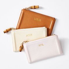 For credit cards, business cards, a bit of cash or any small, precious items, the Emily zip case is made from gorgeous pebbled leather, with a genuine bamboo zipper pull and an unexpected, but classic, striped lining. A perfect gift for birthdays or life milestones, add a foil debossed monogram for a personal touch.  5"w x 3"h  Pebbled leather, bamboo, striped lining (92% polyester, 8% cotton 8%)  Clean with a dry cloth.  Imported.  Monogramming is foil debossed. Classic Zipper Coin Purse For Gift, Classic Coin Purse With Zipper As Gift, Classic Zipper Coin Purse As Gift, Rectangular Zipper Pouch Card Holder Gift, Rectangular Card Holder With Zipper Pouch As Gift, Rectangular Zipper Pouch Card Holder As Gift, Modern Card Holder With Zipper Closure As Gift, Rectangular Coin Purse With Rfid Blocking, Rectangular Rfid Blocking Coin Purse Gift