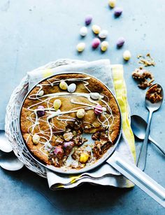 a cake on a table with spoons next to it