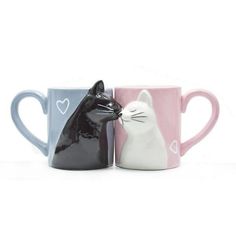 two coffee mugs with cats on them, one has a heart and the other has a cat's head