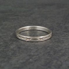 This beautiful vintage Italian band ring is sterling silver with a diamond cut design. Measurements: 3mm wide Size: 7 Marks: Milor, 925 Condition: Excellent Vintage White Gold Stackable Jewelry, Classic Silver Engraved Diamond Cut Ring, Classic Silver Engraved Ring With Diamond Cut, Antique Silver Engraved Ring With Diamond Cut, Vintage Silver Stackable Rings, Vintage Silver Stackable Rings With Round Band, Vintage Stackable Engraved Ring For Anniversary, Vintage Silver Engraved Ring With Decorative Band, Classic Silver Engraved Toe Ring