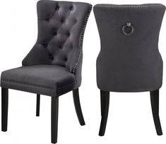 a pair of grey chairs with buttons on the back and side, both facing each other