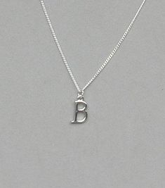 The initial is silver plated and measures 10 mm x 15 mm. It is strung on a silver plated tiny 1.3 mm curb chain with a lobster clasp closure. Choose the length from the drop down. To add a birthstone charm to this necklace, follow link below to purchase the charm. https://www.etsy.com/listing/634099372/add-a-birthstone-charm?ga_search_query=add&ref=shop_items_search_1 Classic Silver Charm Necklaces With Initials, Silver Charm Necklaces With Initials, Simple Silver Charm Necklaces With Initials, Silver Adjustable Initial Pendant Charm Necklace, Sterling Silver Initials Charm Necklace For Birthday, Classic Silver Nickel-free Charm Necklace, Classic Silver Nickel-free Charm Necklaces, Silver Initial Letter Charm Necklace, Spring Reset