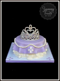 a purple and white cake with a crown on top