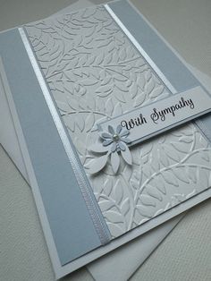 a close up of two cards on top of each other with the words sympathys hugs