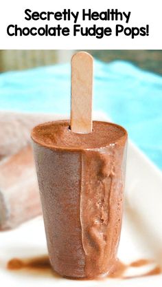 a chocolate fudge pops is sitting on a white plate with the words secret healthy chocolate fudge pops