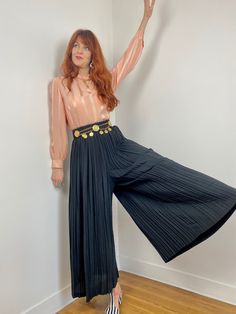 Amazing vintage 80s black high waisted accordion pleat wide leg pants that resemble a maxi skirt. Made in France. FR 34- 40(tight) / UK 6-12 (tight) Waist: (elastic) 30.5-44.5cm - 12-17.5in Hips: very open due to pleating Waist to crotch: 49.5cm - 19.5in Overall length:  103cm - 40.5in Condition: Very good  - no issues to note Material: 100% polyester Closure/Details: slips on Accessories not included but available in other listings - can't find them? Send me a message! NOTES: FOR SHIPPING OUTSIDE OF THE EU, please message me for shipping quotes before purchase -chances are, it may be less! I refund all overages :) Please follow me on Instagram for first looks and chances to buy: www.instagram.com/rebellerougevintage/ If you are interested in a few of my items message us to get the best po Vintage High Waist Wide Leg Pants For Fall, Wide Leg Full Length Pants For Spring Evening, Spring Evening Wide Leg Full Length Pants, High Waist Pleated Bottoms For Party, Wide Leg Flare Pants For Evening In Spring, Black Accordion Pleats Bottoms For Night Out, Spring Evening Flare Wide Leg Pants, Retro Pleated Bottoms For Fall, Fitted Pleated Pants For Party