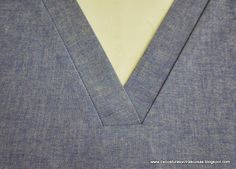 the collar of a gray suit with a white shirt underneath it