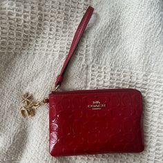 Never Used, Wristlet With Charms Red Coach Clutch For Gift, Red Coach Clutch As A Gift, Chic Red Coach Wallet, Elegant Red Coach Wallet, Coach Red Wristlet With Zipper Pouch, Coach Red Wristlet With Zipper Closure, Red Coach Wristlet With Zipper Closure, Red Coach Rectangular Wristlet, Coach Red Wristlet With Wrist Strap