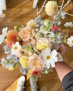 a bouquet of flowers sitting on top of a wooden floor