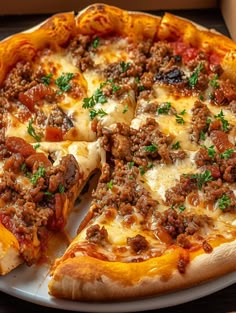 a pizza with meat and cheese on a plate