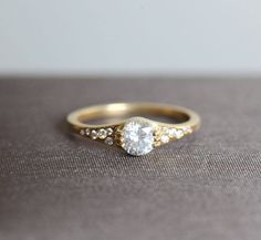 a close up of a gold ring with a diamond on it's center stone