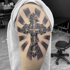 a man with a cross tattoo on his arm