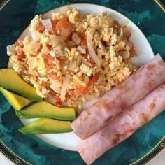 two sausages and rice on a plate with avocado