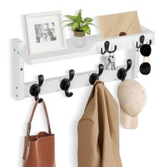 a white coat rack with hats, sunglasses and purses hanging from it's hooks