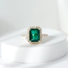 Product Details Add a touch of elegance and beauty to your look with this exquisite Created Emerald Engagement Ring. This simple yet stunning ring features a radiant Created Emerald that is sure to brighten up even the dullest of days. The Created Emerald is further enhanced by delicate Diamond, adding a touch of sparkle and glamour to the ring. Flaunt your style and sophistication with this remarkable Created Emerald Ring, and make a statement wherever you go. Product Information SKU SHP-RINGS112028732 Width 4 mm Height 11.5 mm Weight 2.14 gm (Approximate) LAB CREATED EMERALD INFORMATION No.of Stones 1 Pieces Total Weight 2.31 Carat (Approximate) Dimension(approx) Emerald Cut-7X9 mm-1 Pcs Color Green Cut Brilliant Shape Emerald Cut Setting Type Prong-Setting Quality Grade AAAA DIAMOND INF Emerald Ring With Diamond Halo, Emerald Cut Emerald Engagement Ring, Engagement Rings Emerald Green, Emerald Green Rings, Emerald Stone Engagement Ring, Emeralds Rings, Emerald Jewelry Ring, Green Engagement Ring, Engagement Rings Emerald