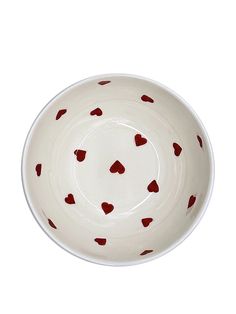 a white bowl with red hearts on it